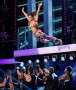 I'm Back Eveerybody! What an entrance! Cheryl Cole swan dives onto stage in a leopard print bra-let and colourful genie trousers to debut Call My Name on The Voice